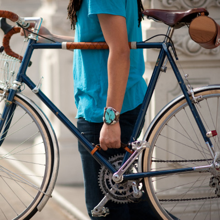 man holding bike by leather strap man holding bike by leather strap