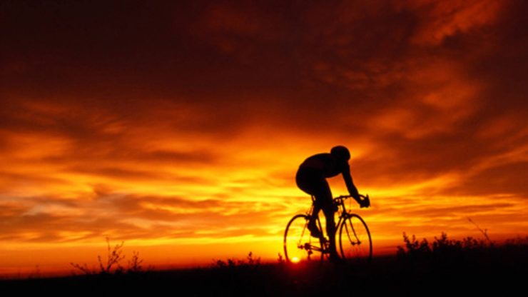 solo bike ride at sunset a rider enjoys the health benefits of biking solo at sunset