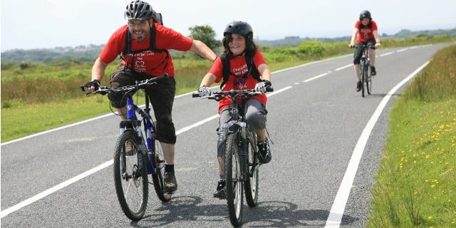 charity bicycle ride two riders do a charity bike ride as a benefit of biking