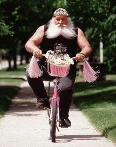 pink bike riding man gruff man on pink bike proves a biking benefit is that it is non judgmental